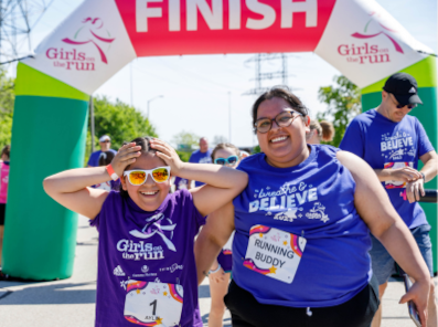 Girls on the Run participant crossing the finish line